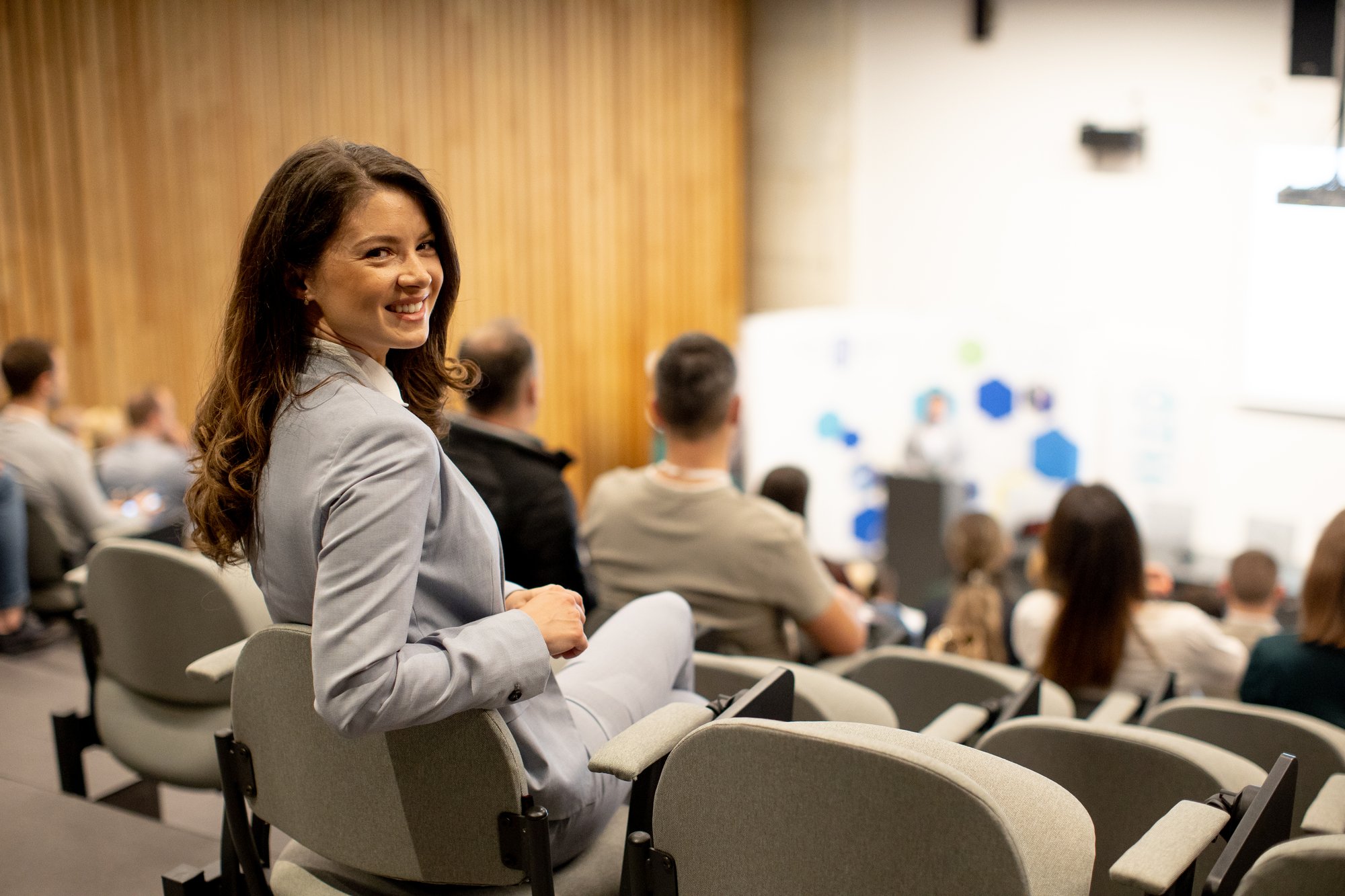 young-woman-sitting-in-audience-on-conference-or-w-2025-02-21-01-57-10-utc